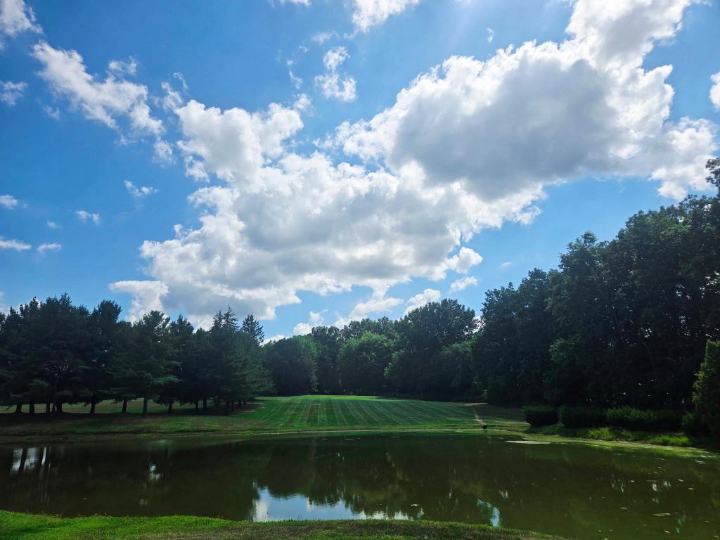 Bright sky above the golf course fairway